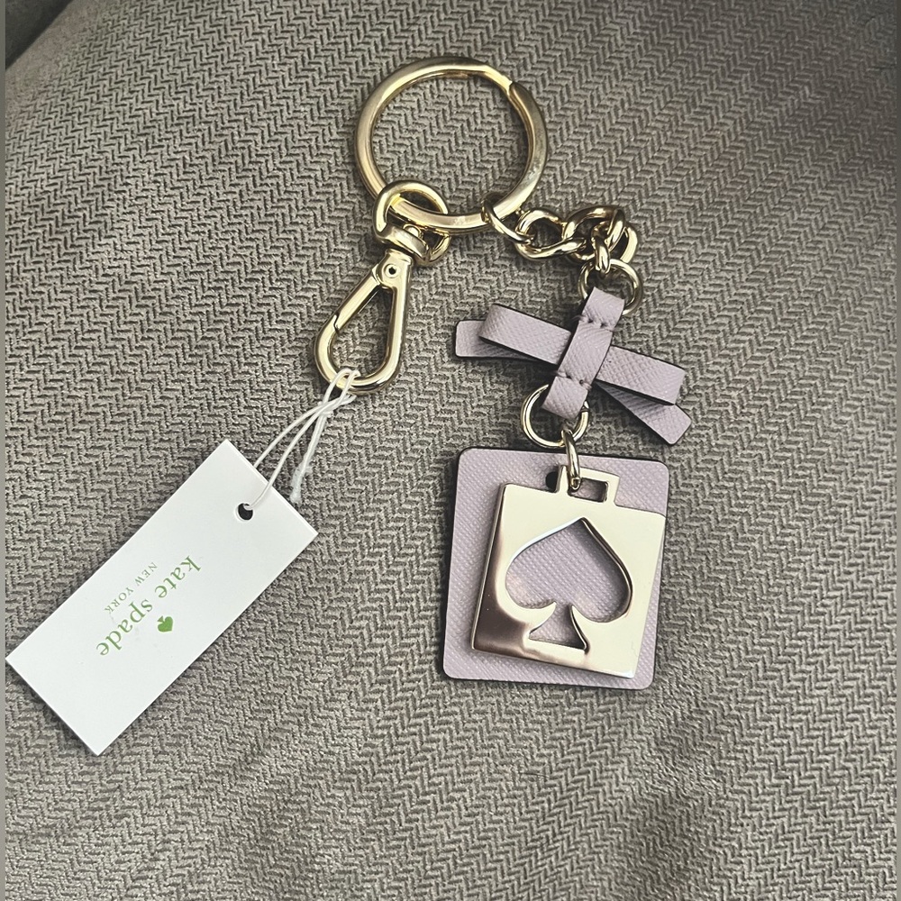 NWT Beautiful Lilac Kate Spade Keychain/Key Fob. Comes with travel bag and box.